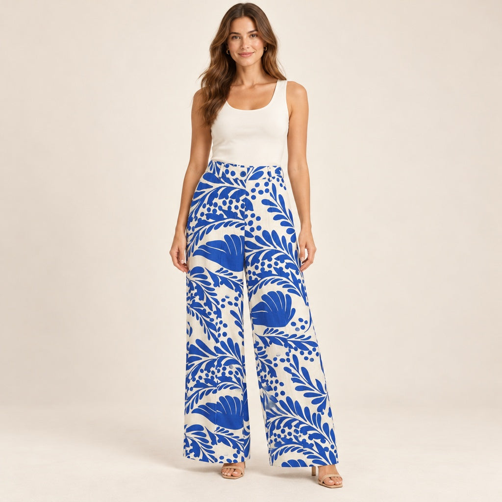 Modelo virtual creada con IA — ivory white wide-leg trousers with exact large cobalt blue tropical leaves and floral print, blue waist button