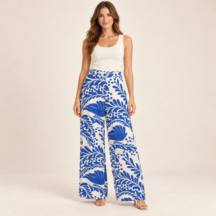 Modelo virtual creada con IA — ivory white wide-leg trousers with exact large cobalt blue tropical leaves and floral print, blue waist button